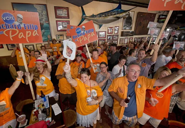 Supporters of Richard Filip cheer for their contestant during the final round of the “Papa” Hemingway Look-Alike Contest in this handout photo provided by the Florida Keys News Bureau at Sloppy Joe's Bar in Key West, Florida July 19, 2014. Wally Collins, a Phoenix resident, won the title on his sixth try during the event that was the highlight of Key West's annual Hemingway Days festival. (Photo by Andy Newman/Reuters/Florida Keys News Bureau)