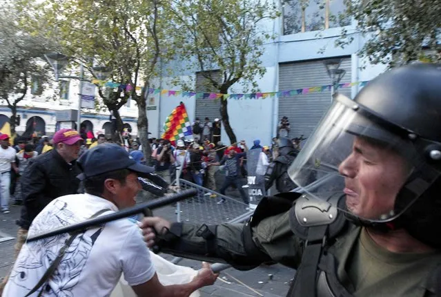 Demonstrators clash with the police during a march in Quito, Ecuador, August 13, 2015. (Photo by Guillermo Granja/Reuters)