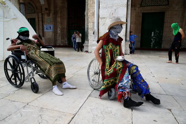 Masked Palestinians rest in wheelchairs before clashes with Israeli police erupted during the holy month of Ramadan on the compound known to Muslims as Noble Sanctuary and to Jews as Temple Mount in Jerusalem's Old City June 28, 2016. An Israeli police spokesman said on Tuesday that the compound would be closed to visitors, including Jewish visitors, for three days in response to clashes, in which masked Palestinians threw stones at Israeli policemen and some 16 suspects were detained by the police. (Photo by Ammar Awad/Reuters)