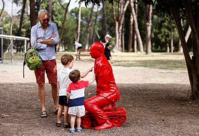 Children touch a life-size statue of Russian President Vladimir Putin riding a tiny tank created by French artist James Colomina in Villa Borghese in Rome, Italy on August 3, 2023. (Photo by Yara Nardi/Reuters)