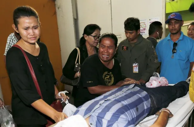 Relatives cry near the body of Thai victim Suwan Sudmun after Monday's bomb blast, at the Institute of Forensic Medicine in Bangkok, Thailand, August 18, 2015. (Photo by Chaiwat Subprasom/Reuters)