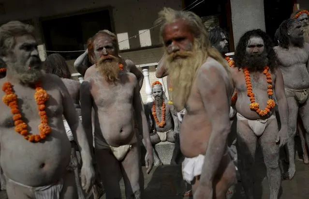 Naga sadhus, or Hindu holy men, wait inside their camp before a procession during Kumbh Mela or the Pitcher Festival in Trimbakeshwar, India, August 27, 2015. (Photo by Danish Siddiqui/Reuters)