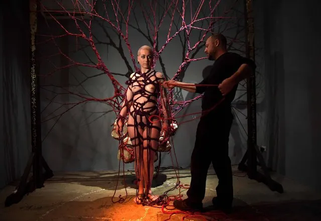 Artist Garth Knight (R) prepares performer Gemma Watkinson (L) to incorporate her into his performance work titled Effloresce at a preview of the Sydney Contemporary Art Fair on September 6, 2017. The fair is Australasia's premier international art fair, with more than 80 leading Australian and international exhibitors from around the pacific rim and further afield including China, Hong Kong, The Philippines, Singapore, Chile and New Zealand. (Photo by William West/AFP Photo)