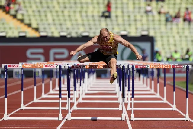 Arthur Abele, of Germany, runs alone in a Men's decathlon 110 meters hurdles heat during the athletics competition in the Olympic Stadium at the European Championships in Munich, Germany, Tuesday, August 16, 2022. Abele was disqualified from his original heat and then allowed to run a heat on his own after the decision was revised. (Photo by Martin Meissner/AP Photo)