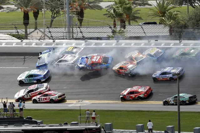 Chris Buescher (17), Daniel Suarez (99), Denny Hamlin (11), Justin Haley (31), Ricky Stenhouse Jr. (47), Aric Almirola (10) and others get involved in a multi-car accident between Turns 1 and 2 during a NASCAR Cup Series auto race at Daytona International Speedway, Sunday, August 28, 2022, in Daytona Beach, Fla. (Photo by David Graham/AP Photo)