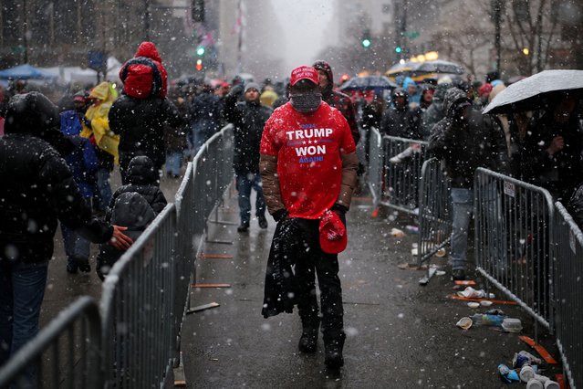 A man wearing the MAGA hat walks as supporters of President-elect Donald Trump gather outside Capital One Arena, for a rally a day before he is scheduled to be inaugurated for a second term, in Washington, on January 19, 2025. (Photo by Daniel Cole/Reuters)