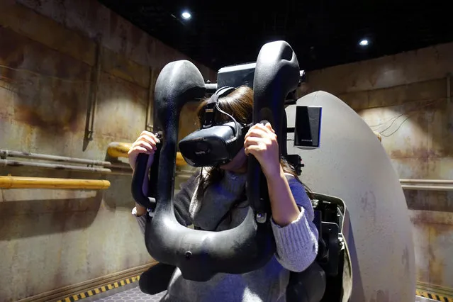 A staff member demonstrates a test-run of the virtual reality (VR) attraction “Explore the Stars” on November 24, 2017. The $1.5-billion Oriental Science Fiction Valley park, is part of China's thrust to develop new drivers of growth centered on trends such as gaming, sports and cutting-edge technology, to cut reliance on traditional industries. (Photo by Joseph Campbell/Reuters)