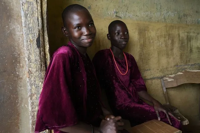 Twins Taiwo Lateef, left, and Kehinde Lateef, 13, from Igbo-Ora town and students of Igbo-Ora grammar secondary school attends the annual twins festival in Igbo-Ora South west Nigeria, Saturday, October 8, 2022. The town holds the annual festival to celebrate the high number of twins and multiple births. (Photo by Sunday Alamba/AP Photo)