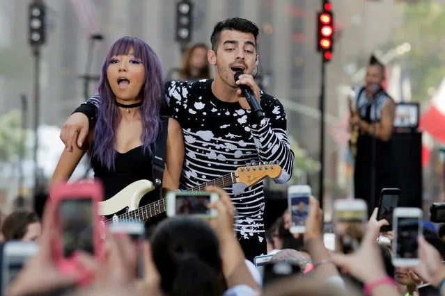Singer Joe Jonas (R) and guitar player JinJoo Lee of the group DNCE perform during NBC's “Today” show Summer Concert Series in New York City, U.S., August 26, 2016. (Photo by Brendan McDermid/Reuters)