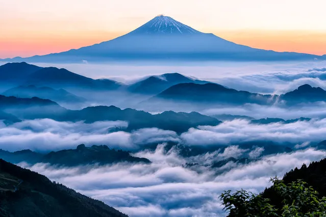 “A Daybreak”. I went up through thick clouds to the high point expecting to get above it. As darkness went out, Mt. Fuji appeared above the sea of clouds in the red sky. Photo location: Shizuoka, Japan. (Photo and caption by Hidetoshi Kikuchi/National Geographic Photo Contest)