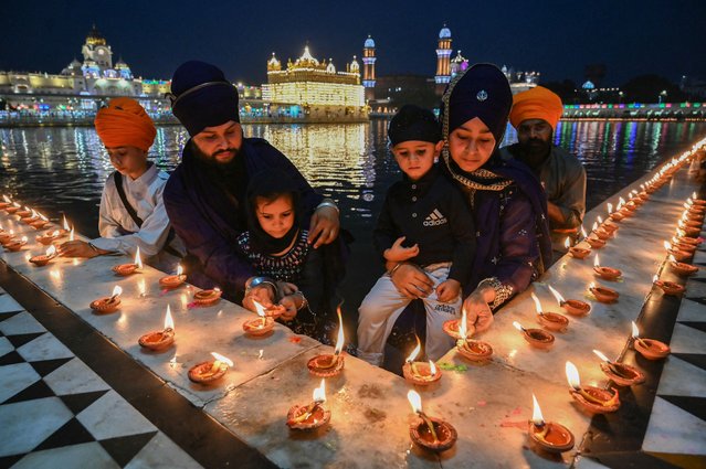 Sikh devotees light earthen lamps on the occasion of 'Baisakhi', a spring harvest festival, at the Golden Temple in Amritsar on April 13, 2025. (Photo by Narinder Nanu/AFP Photo)