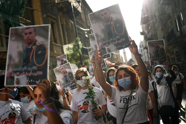 People hold a vigil for the victims lost in a massive explosion in Beirut, Lebanon August 11, 2020. (Photo by Hannah McKay/Reuters)