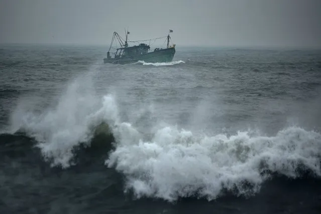 An Indian fishing trawler sails amid rough sea conditions during cyclone Mandous, at Kasimedu fishing harbor, in Chennai, India, 08 December 2022. The Indian Meteorological Department (IMD), on 08 December 2022, forecasts very heavy rainfall across Tamil Nadu, Puducherry, and Andhra Pradesh as cyclone Mandous is expected to make landfall over southeast India. (Photo by Idrees Mohammed/EPA/EFE/Rex Features/Shutterstock)