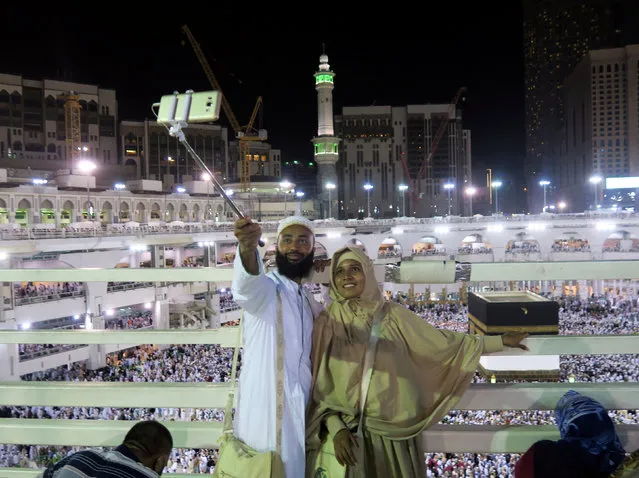 Two Muslim couple take a selfie as Muslim pilgrims circle the Kaaba at the Grand Mosque in Mecca September 4, 2016. (Photo by Ahmed Jadallah/Reuters)