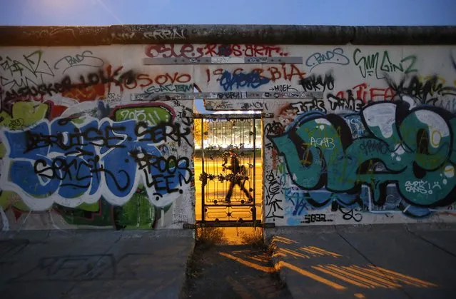 A door is seen at painted sections of the East Side Gallery, the largest remaining part of the former Berlin Wall, in Berlin, November 3, 2014. Germany will celebrate the 25th anniversary of the fall of the wall on November 9. (Photo by Fabrizio Bensch/Reuters)