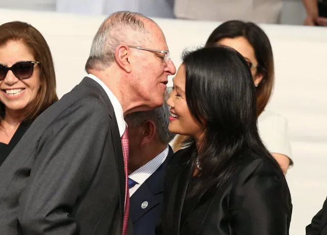 Peru's President Pedro Pablo Kuczynski (L) greets Keiko Fujimori, leader of the Popular Force party, as they wait along with others for Pope Francis to arrive, in Lima, Peru January 19, 2018. (Photo by Mariana Bazo/Reuters)