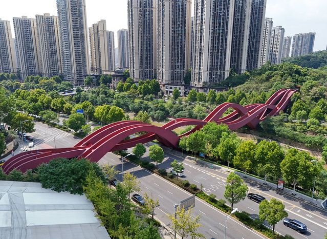 An aerial footage shows the sexiest bridge shaped like Chinese knotting built with 800 tons of steel at a cost of 300 million yuan on the Longwangang River beside Meixi Lake in Changsha, Central China's Hunan province, Sept 9, 2024. The bridge has a total of 3 walking paths and 5 nodes, consisting of a straight "walking path" and an arched "hiking path". The middle path is the gentler, while the east-west path takes three up and three down. With a total length of 183.95 meters, a total width of 11.5 meters and a height of about 24 meters, the bridge is made of more than 800 tons of different types of square steel, each of which is irregular shaped steel. Inspired by the classic Moebius ring and ancient folk art Chinese knotting, it has been selected as one of the top ten “sеxiest buildings in the world” by CNN. (Photo credit should read CFOTO/Future Publishing via Getty Images)
