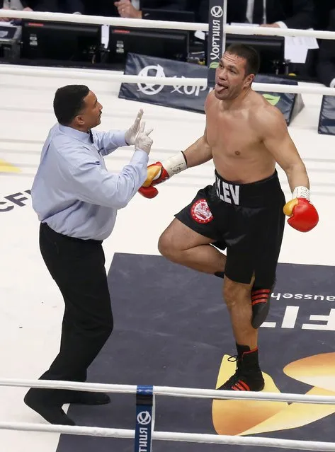 Challenger Bulgarian Kubrat Pulev jokes with the referee after being knocked down by Ukrainian WBA, WBO, IBO and IBF heavyweight boxing world champion Vladimir Klitschko (not pictured) during their title fight in Hamburg, November 15, 2014. (Photo by Morris Mac Matzen/Reuters)