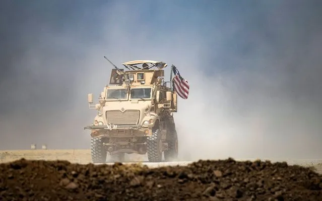 A U.S. military vehicle patrols near the Rumaylan oil fields in Syria's Kurdish-controlled northeastern Hasakah province, on September 17, 2020. (Photo by Delil Souleiman/AFP Photo) 