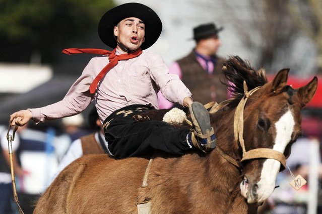 Sebastian Campos rides a horse at a rodeo celebrating Independence Day in San Isidro, Argentina, Wednesday, July 9, 2025. (Photo by Natacha Pisarenko/AP Photo)