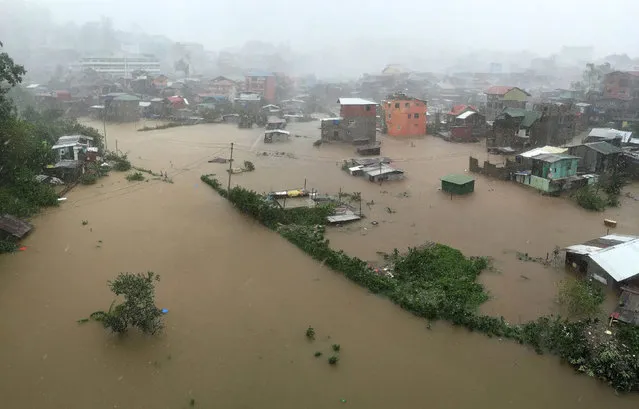 Houses, partially submerged in floods waters caused by heavy rains brought by Typhoon Koppu, are seen in City Camp Lagoon at Baguio city, north of Manila October 19, 2015. Typhoon Koppu swept across the northern Philippines killing at least nine people as trees, power lines and walls were toppled and flood waters spread far from riverbeds, but tens of thousands of people were evacuated in time. (Photo by Harley Palangchao/Reuters)