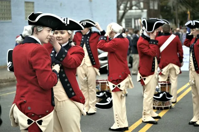 The United States Army Old Guard Fife and Drum Corps fine tuning their uniforms before the start of the George Washington Birthday Parade in  Alexandria, Virginia on February 20, 2023. (Photo by Marvin Joseph/The Washington Post)