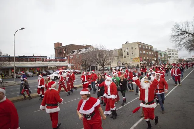 People in Santa Claus outfits participate in the “Running of the Santas” in Philadelphia, Pennsylvania December 13, 2014. (Photo by Mark Makela/Reuters)