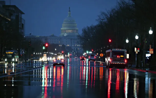 Capitol Hill is seen in the distance as rain falls on Pennsylvania Avenue in Washington, early Friday, March 31, 2017. (Photo by J. Scott Applewhite/AP Photo)