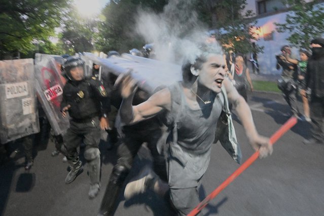 Demonstrators clash with the police during a pro-Palestinian rally called “Urgent action for Rafah”, held in front of the Israeli embassy in Mexico City on May 28, 2024. (Photo by Pedro Pardo/AFP Photo)