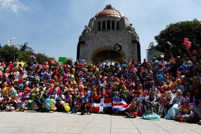 Clowns pose for the annual picture as part of the XXI Convention of Clowns, at the Monument to the Revolution, in Mexico City, Mexico, October 19, 2016. (Photo by Carlos Jasso/Reuters)