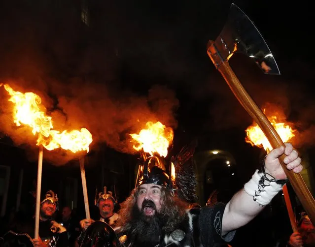 Up Helly Aa vikings from the Shetland Islands hold lit torches during the annual torchlight procession to mark the start of Hogmanay (New Year) celebrations in Edinburgh, Scotland December 30, 2014. (Photo by Russell Cheyne/Reuters)