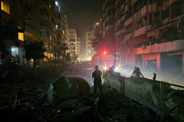 Emergency workers are seen amid damaged buildings and debris in the aftermath of an Israeli airstrike that targeted the Hadath neighborhood in the southern suburbs of Beirut on June 6, 2025. A series of Israeli air strikes hit Beirut's southern suburbs on the night of June 5, after the military said it would target underground Hezbollah drone factories. Plumes of smoke were seen billowing from the Lebanese capital, shortly after huge numbers of people had fled the area, clogging the roads with traffic. (Photo by AFP Photo/Stringer)