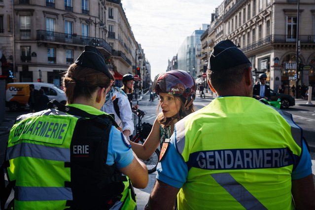 French Gendarmerie officers check pedestrians and cyclists QR codes and luggages at a barriers checkpoint to circulate near the Louvre Museum in Paris on July 18, 2024, ahead of the opening ceremony of the Paris 2024 Olympic Games. French security forces began locking down large parts of central Paris on July 18, 2024, ahead of the hugely complex Olympics opening ceremony the week after on the river Seine. The opening parade along six kilometres (four miles) of the river led to the closure of riverside central districts to most vehicles from 5:00 am (0300 GMT) on July 18. (Photo by Dimitar Dilkoff/AFP Photo)