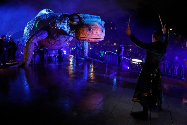 A 20-metre long puppet of a giant newt called Alf, created by the street performance group Macnas, is walked through the streets during their Halloween parade called 'Alf's Journey' inspired by climate change and habitat loss, in Galway, Ireland on October 27, 2024. (Photo by Clodagh Kilcoyne/Reuters)
