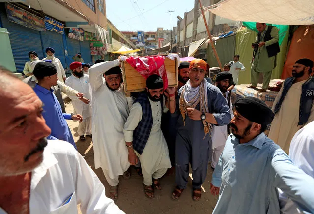 Afghan Sikh men carry the coffin of one of the victims of yesterday's blast in Jalalabad city, Afghanistan July 2, 2018. (Photo by Reuters/Parwiz)