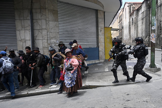 People run as riot police disperse them during protest against what demonstrators say are food shortages and the rise in the prices of the food basket, in La Paz, Bolivia on January 14, 2025. (Photo by Claudia Morales/Reuters)