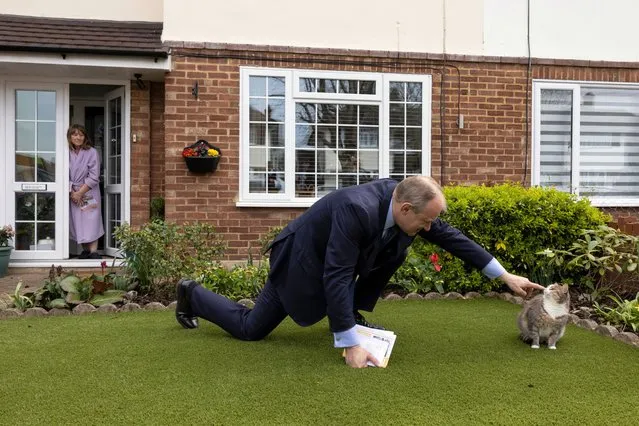 Liberal Democrat leader Ed Davey attempts to stroke Mikee the cat after speaking with resident Kate Allden, while canvassing ahead of the local elections, on April 12, 2022 in Watford, England. Local elections in will be held on May 5, 2022. (Photo by Dan Kitwood/Getty Images)