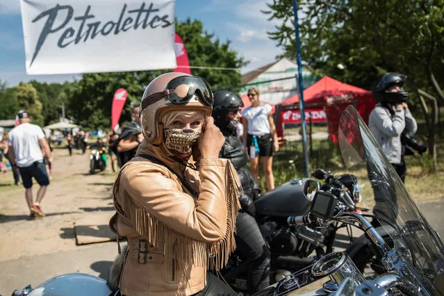 Participant waits for a ride out at the women's-only Petrolettes motorcycle festival on July 21, 2018 in Milmersdorf, near Berlin in Germany. (Photo by Maja Hitij/Getty Images)