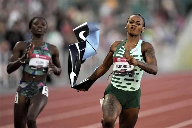 Sha'Carri Richardson grabs the tape as she wins the women's 100 meter finals ahead of Tamara Clark during the U.S. track and field championships in Eugene, Ore., Friday, July 7, 2023. (Photo by Ashley Landis/AP Photo)