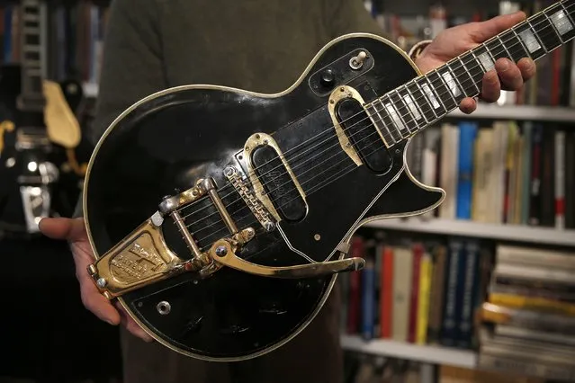 Guernsey's Auctions President Arlan Ettinger holds the Les Paul guitar known as “Black Beauty”, which will go up for auction next month, in New York January 29, 2015. The electric instrument, which is the original prototype for the Les Paul Custom guitars made the Gibson Guitar Company, will be sold by Guernsey's Auctions at the Arader Galleries on February 19. (Photo by Mike Segar/Reuters)