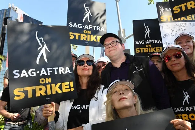 SAG-AFTRA President Fran Drescher (C L), with National Executive Director & Chief Negotiator, Duncan Crabtree-Ireland (C R) and actress Frances Frances Fisher (C bottom), joins Writers Guild members at a picket line outside Netflix in Los Angeles on July 14, 2023. Tens of thousands of Hollywood actors went on strike at midnight July 13, 2023, effectively bringing the giant movie and television business to a halt as they join writers in the first industry-wide walkout for 63 years. (Photo by Valerie Macon/AFP Photo)