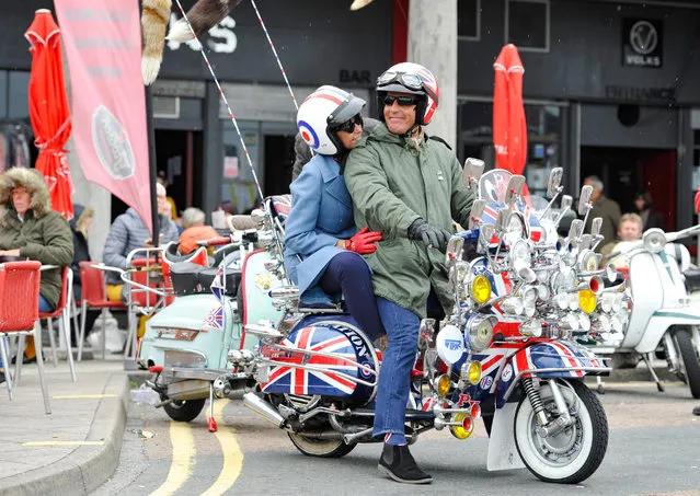 Despite the bad weather Mods with their scooters descend on Brighton seafront as part of their Mod Weekender event in Brighton, UK on August 26, 2018. . Every August Bank Holiday hundreds of Mods from around the country descend on Brighton for their traditional event which depending on the weather includes a ride out to Beach Head inspired by the film “Quadrophenia”. (Photo by Simon Dack/Alamy Live News)