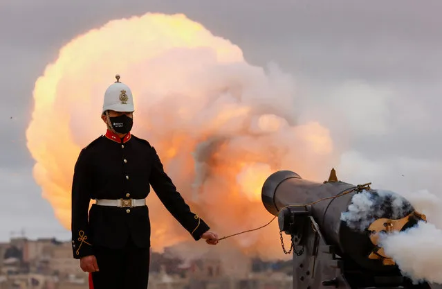 Reenactors of the Malta Heritage Trust fire a nine-gun salute to honour Britain's Prince Philip before his funeral, at the Upper Barrakka Saluting Battery overlooking Grand Harbour, in Valletta, Malta on April 17, 2021. (Photo by Darrin Zammit Lupi/Reuters)