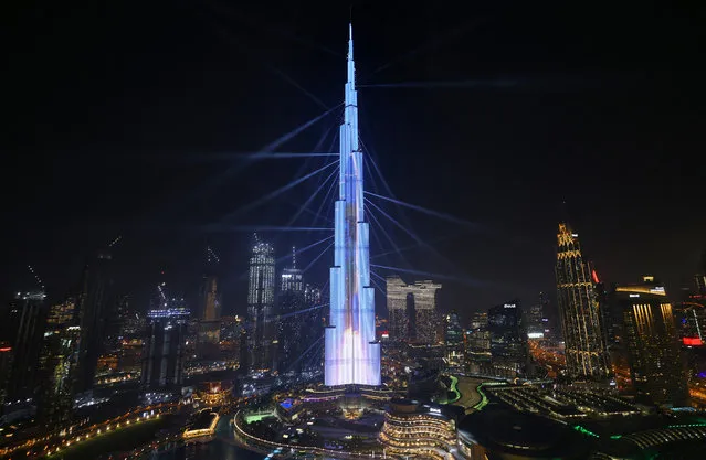 The launch of a rocket into space is projected on Dubai's Burj Khalifa on February 9, 2021 as the UAE's “Al-Amal” – Arabic for “Hope” – probe's to Mars carries out a tricky manoeuvre to enter the Red Planet's orbit. A tense half-hour today will determine the fate of “Hope”. If successful, the probe which is designed to reveal the secrets of Martian weather, will become the first of three spacecraft to arrive at the Red Planet this month. (Photo by Giuseppe Cacace/AFP Photo)