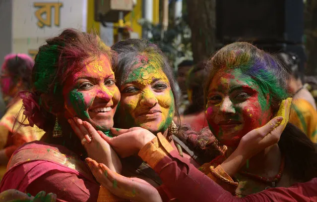 Indian revellers cover each other with coloured powder during the celebrations of Vasantotsav, 'the Festival of Spring', in Siliguri on March 5, 2015. Vasantotsav, which is celebrated in the rest of India as Holi, is celebrated as a welcoming of Spring and a celebration of the triumph of good over evil with people chasing each other and playfully splashing colorful paint, powder and water on each other. AFP PHOTO / Diptendu DUTTA        (DIPTENDU DUTTA/AFP/Getty Images)