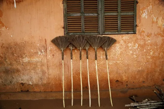 Locally made brooms are displayed for sale by the side of a building in Ouidah, Benin January 10, 2016. (Photo by Akintunde Akinleye/Reuters)