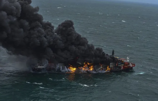 In this photo provided by Sri Lanka Air Force, smoke rises from the container vessel MV X-Press Pearl engulfed in flames off Colombo port, Sri Lanka, Tuesday, May 25, 2021. An explosion occurred Tuesday on a ship anchored off Sri Lanka's capital on which a fire had been burning for several days, prompting the evacuation of all crew members, officials said. (Photo by Sri Lanka Air Force via AP Photo)