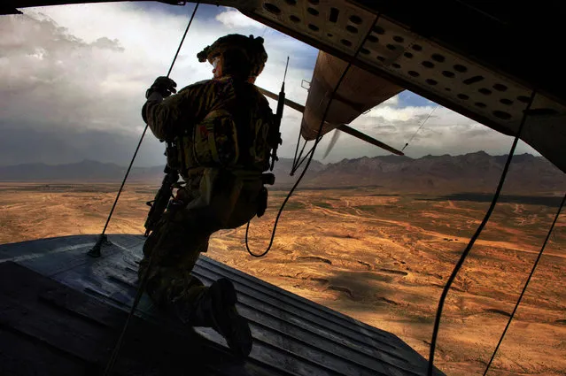 U.S. Air Force Tech. Sgt. Josh Martin, 438th Air Expeditionary Advisory Squadron, Mi-17 aerial gunner, provides rear security on a Mi-17 helicopter, Kabul, Afghanistan, May 31, 2014. Martin, a Rapid City, S.D. native, is deployed from the 55th Rescue Squadron, Davis Monthan Air Force Base, Ariz. The 438th AEAS and Afghan Air Force have combined efforts to train with about 300 Afghan commandos with the 8th Commandos Kandak. (Photo by Staff Sgt. Vernon Young/U.S. Air Force)