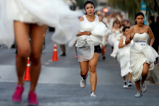 Brides compete during the “Running of the Brides” race event in Bangkok, Thailand on November 24, 2018. The winner receives a fully sponsored wedding as a prize. (Photo by Soe Zeya Tun/Reuters)