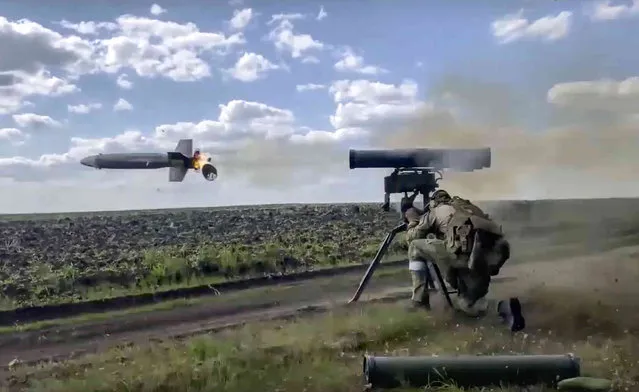 In this handout photo taken from video released by Russian Defense Ministry Press Service on Monday, August 29, 2022, a Russian soldier fires from a Kornet, a Russian man-portable anti-tank guided missile on a mission at an undisclosed location in Ukraine. (Photo by Russian Defense Ministry Press Service via AP Photo)